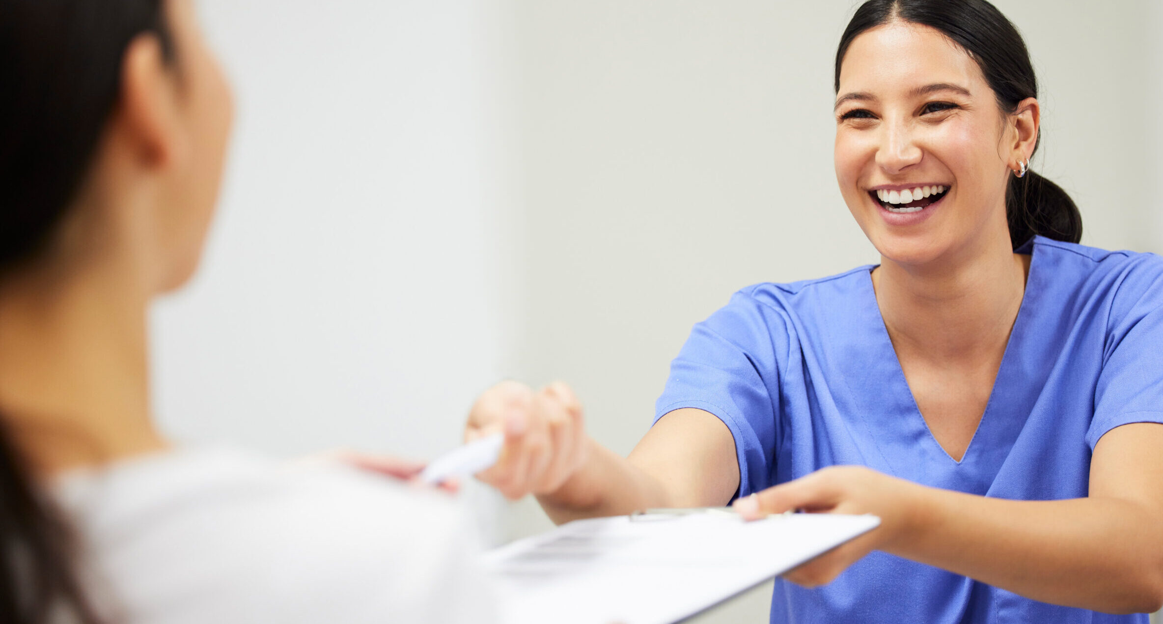 Documents, happy and a nurse helping a patient in the hospital during an appointment or checkup. Insurance form, smile and a medical assistant at a health clinic to help with check in or sign up.